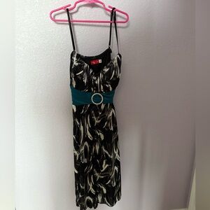Black/grey/white midi dress with teal bow.